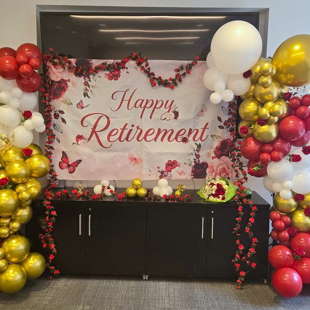 Red and gold retirement party balloon garland